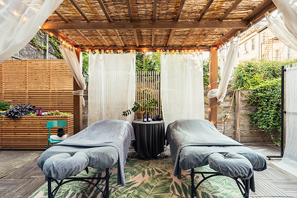 two massage tables outside in the Pergola