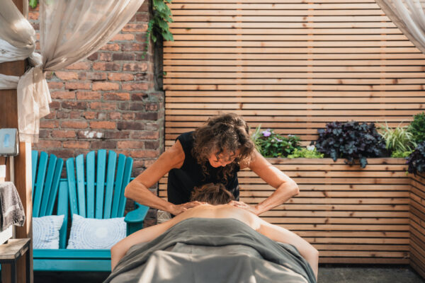 Liz (owner of cityWell brooklyn) giving a full body. massage to a client at Gowanus location